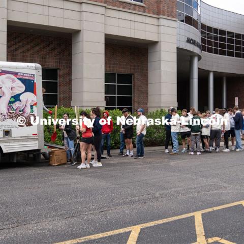 Big Event student volunteers line up at gear checkout truck to get tools for the day. May 4, 2024. Photo by Kirk Rangel for University Communication.
